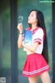 A woman in a red and white uniform holding a book.