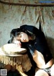 A woman laying on top of a stool in a room.