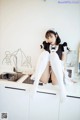 A woman sitting on top of a kitchen counter.