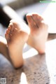 A close up of a person's feet on a table.