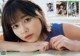 A young woman laying on top of a table.