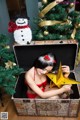 A woman in a red lingerie sitting in a wooden box.