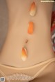 A close up of a woman's stomach with sushi on it.