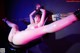 A woman in latex is tied up and tied up to a chair.
