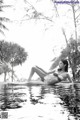 A woman in a bikini laying in a pool.