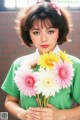 A woman holding a bunch of flowers in her hands.